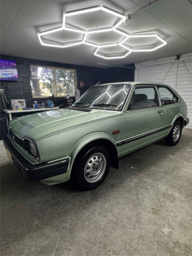 Classic green Honda hatchback with restored paint gloss after professional paint correction in Sydney.