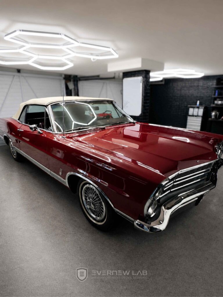 Luxury burgundy convertible after professional car detailing in Sydney, with polished paint and a clean studio finish.