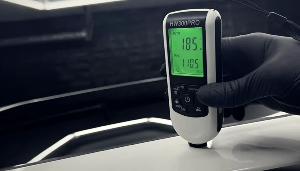 Paint correction Sydney – detailer measuring paint thickness with a paint depth gauge before machine polishing at EverNew Lab, Baulkham Hills