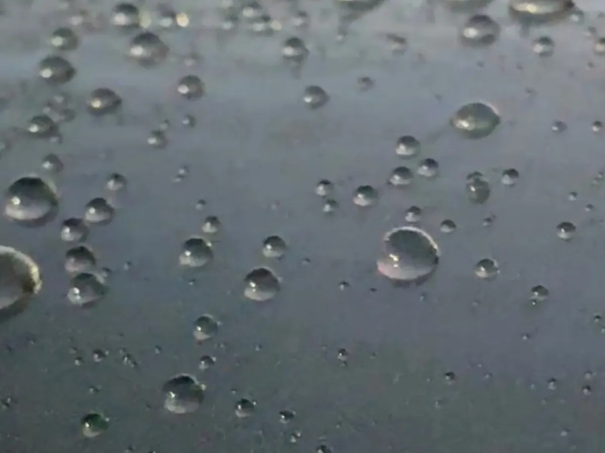 Water beading on a ceramic coated car paint surface